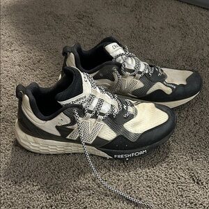 New Balance women’s Black and Cream Sneakers